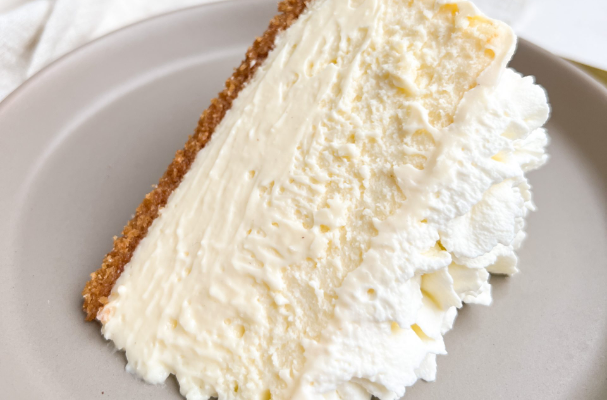 a slice of cheesecake on a small plate, showcasing a thin crust, a smooth and creamy texture