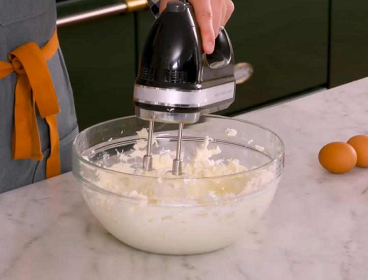 Smooth cream cheese and sugar mixture in a bowl, showcasing its creamy texture.






