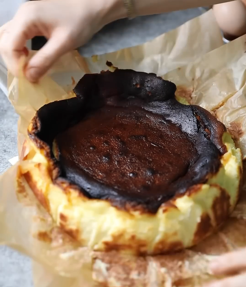 Overhead view of a burnt Basque cheesecake with its signature dark, caramelized top.






