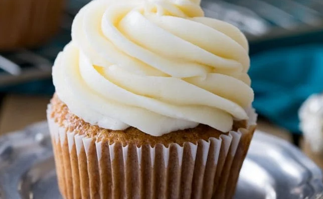 Delicious cupcake topped with a smooth layer of cream cheese frosting