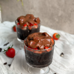 two glasses of chocolate pudding with strawberries