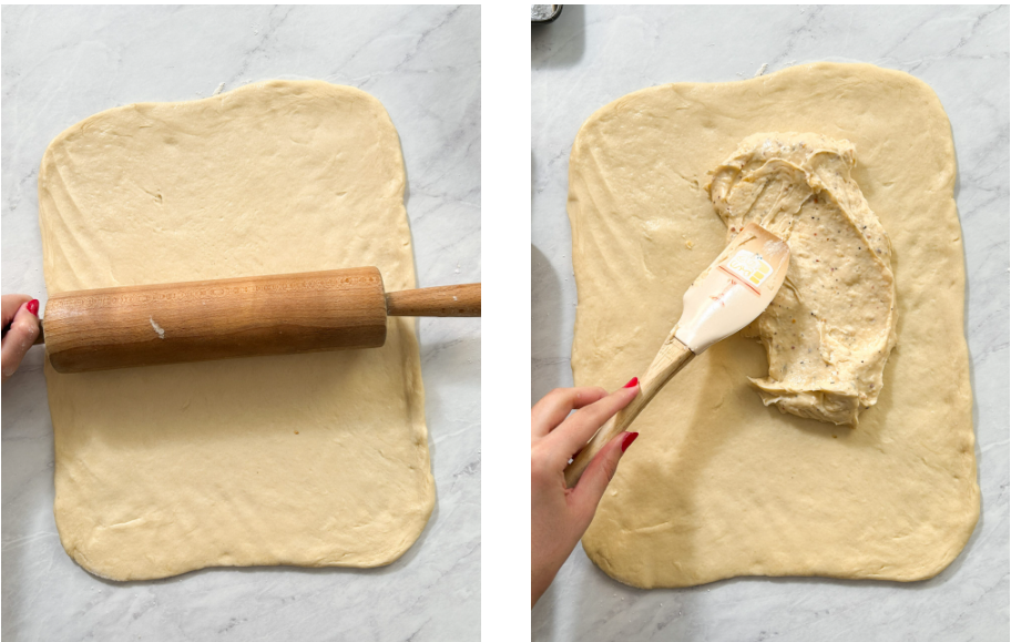 Using a rolling pin to shape soft dough into a rectangle, followed by a spatula spreading creamy cheese sauce evenly over the rolled dough.